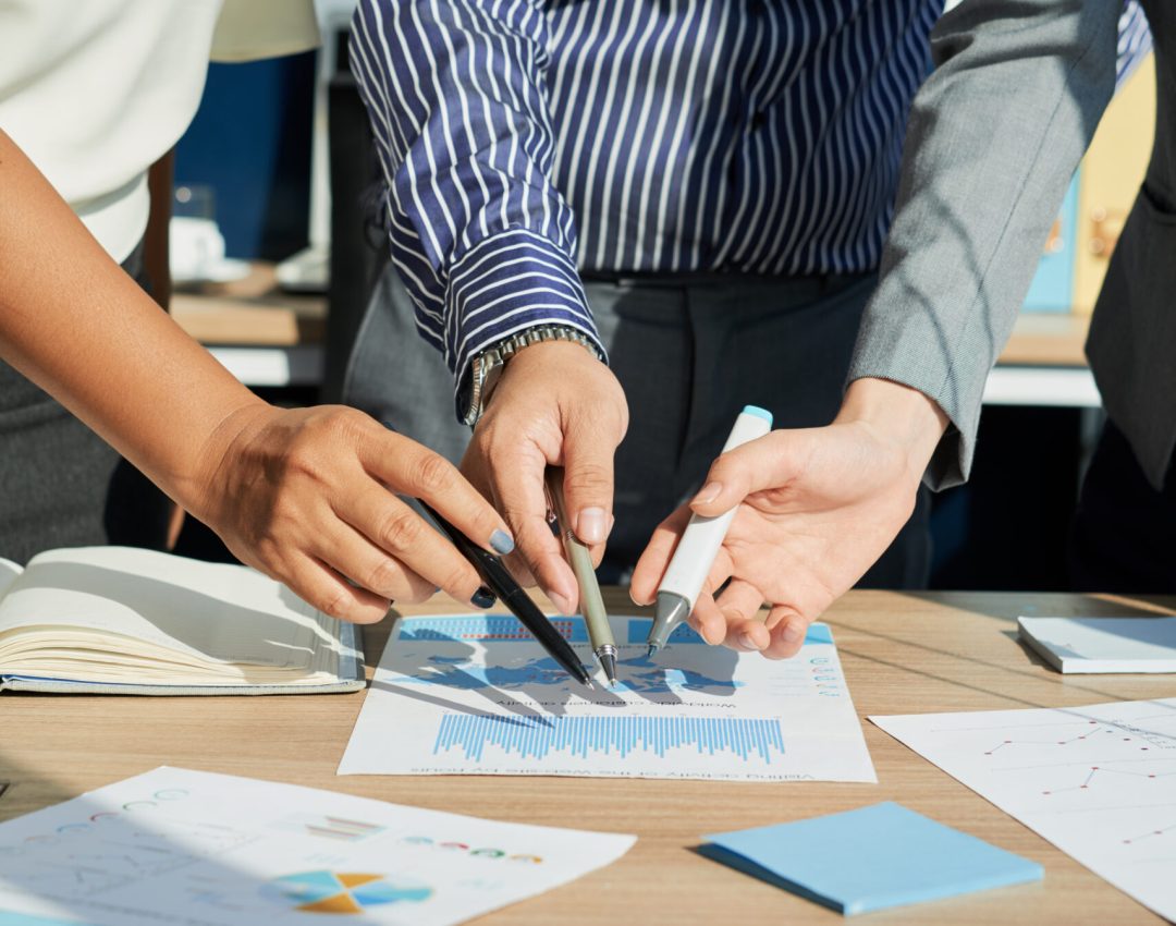 Cropped image of business executives analyzing financial statistics